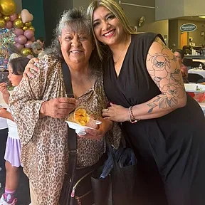 Lily hugging a senior client at a community event